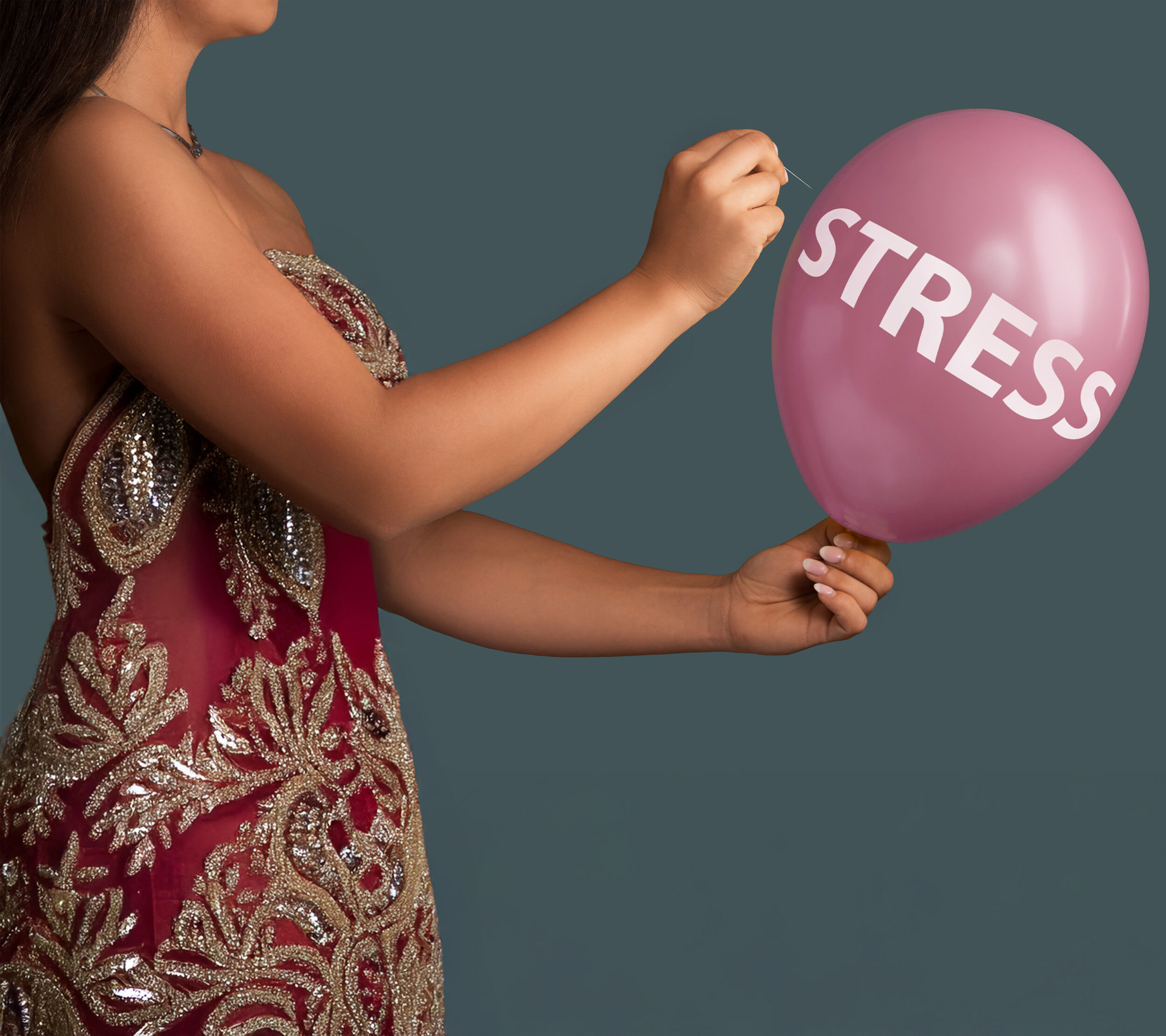 A women poping stress name ballon indicating Goodbye wedding stress! 